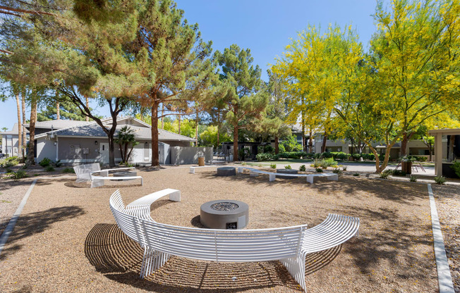 a fire pit and benches in a park with trees at Paisley and Pointe Apartments, Las Vegas, NV