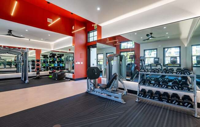 a gym with weights and cardio equipment in a building