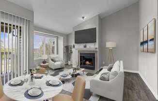 a living room with a fireplace and a table and chairs