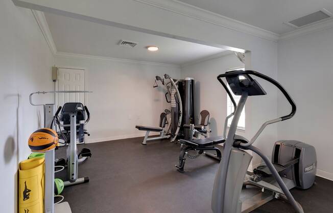 A well-equipped home gym with various exercise machines.