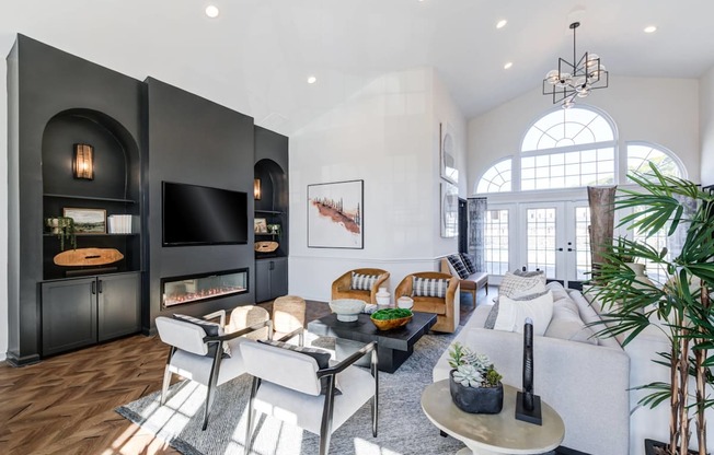 A modern living room with a fireplace and a large window.
