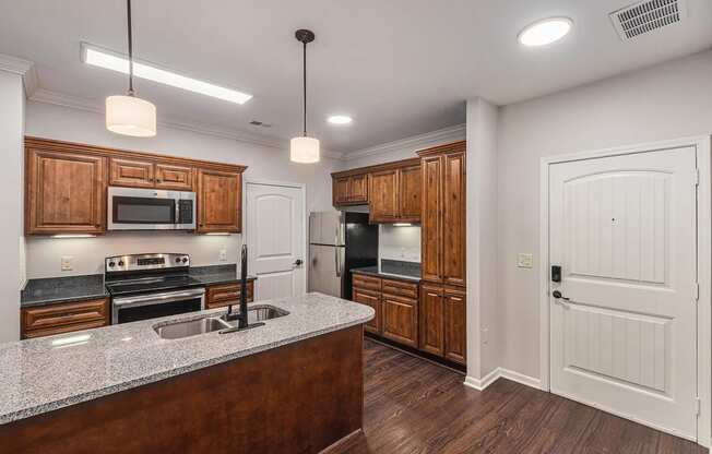 a kitchen with wooden cabinets and a granite counter top