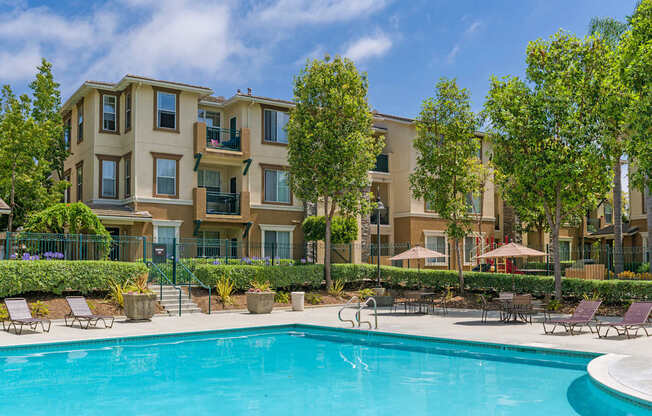 A swimming pool in front of apartment buildings.
