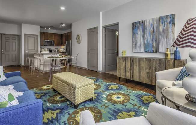 a living room with couches and a rug