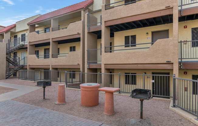Apartment complex with a red roof and a black fence at Urban WalkApartments on 6th Avenue, Arizona 85016