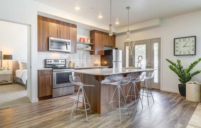 a kitchen with a large island with three stools