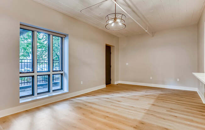 A room with wooden floors and a large window.