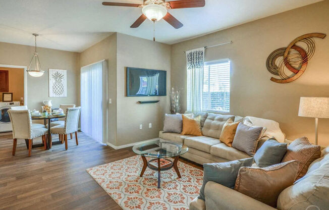 a living room with a couch and a ceiling fan at Villas on Bell, Arizona, 85053