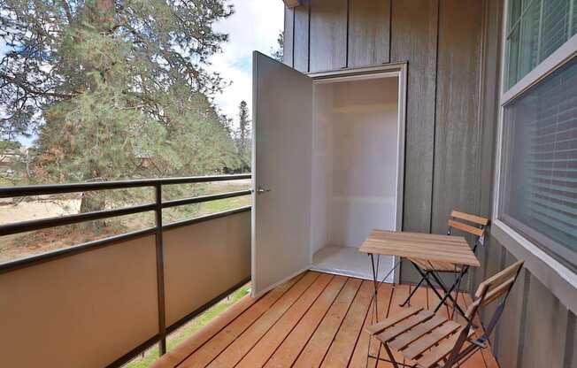 a balcony with a table and chairs on it