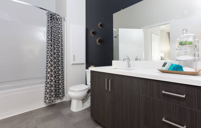 a bathroom with a toilet sink and bathtub in a 555 waverly unit