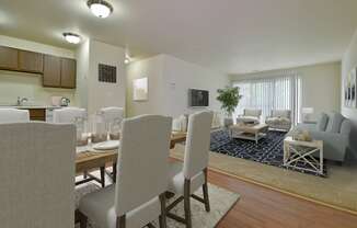 a living room and dining room with a table and chairs