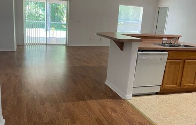 Beautiful 3/2/2 house with laminate floors, tiles, screen porch, luscious lawn, sprinkler system and much more.