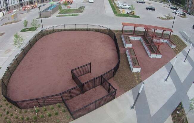 Fenced dog park with agility equipment.