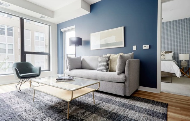 a living room with blue walls and a couch and a coffee table