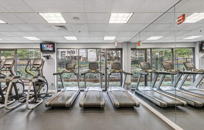 a gym with treadmills and other exercise equipment