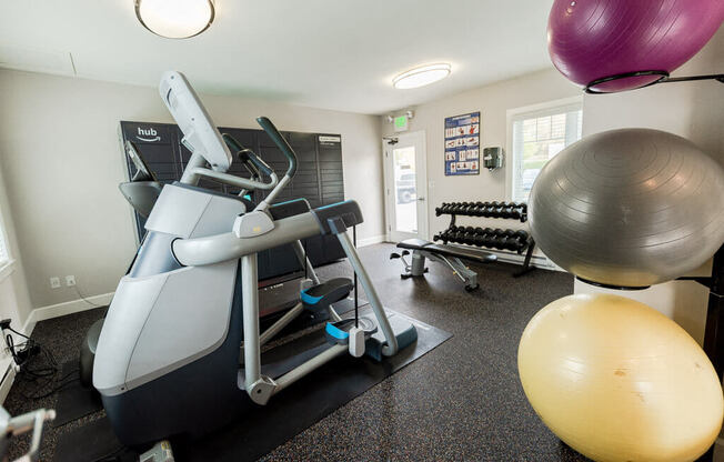 A gym with a treadmill, exercise balls, and weights. at The Aviator, Renton, Washington