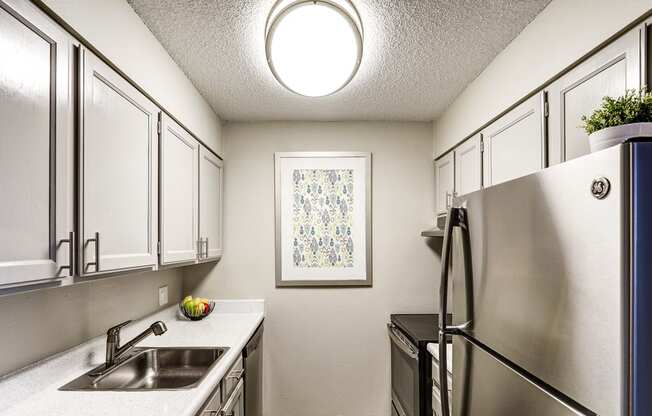 a kitchen with stainless steel appliances and white cabinets