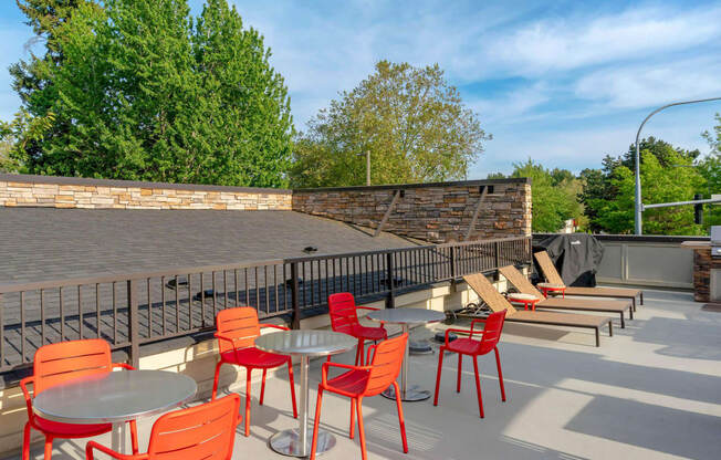 a patio with tables and chairs and a brick wall at Delano, Washington, 98052