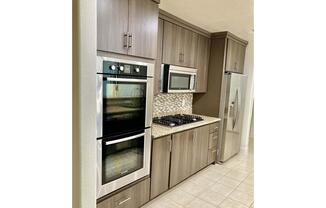 a stove top oven sitting inside of a kitchen