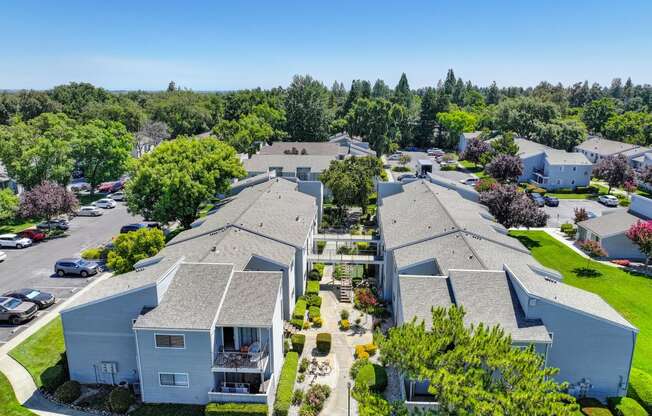 a aerial view of several houses in a neighborhood with trees