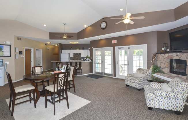 a large living room with a fireplace and a dining table