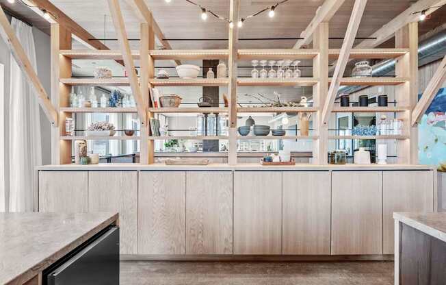 A kitchen with wooden shelves and cabinets.