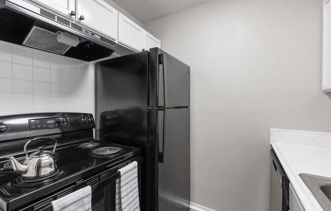 a stove top oven sitting inside of a kitchen