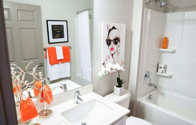 A bathroom with a white toilet and a white sink.