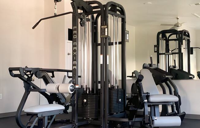 a gym with various machines and weights in it