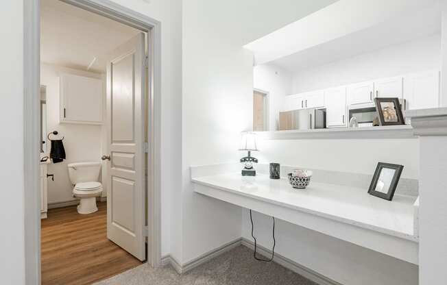 a bathroom with a mirror and a door to the toilet