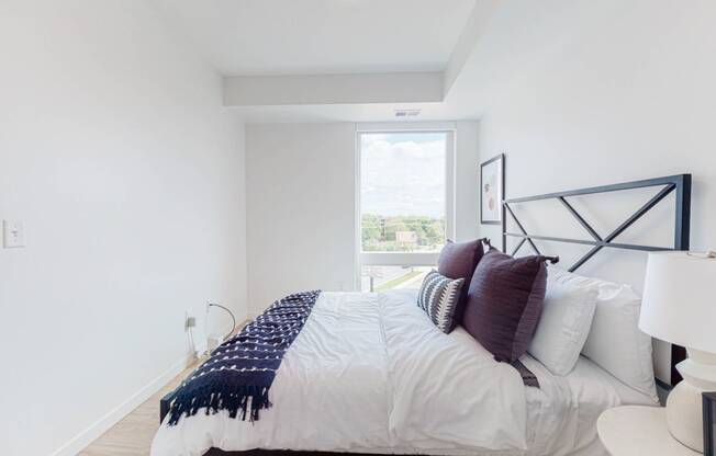 Bedroom with cozy bed at CityLine Apartments, Minneapolis