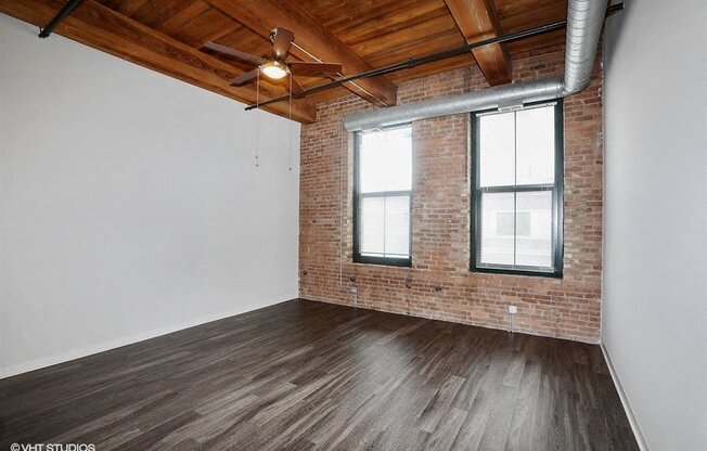 Spacious living area with stunning brick wallsat Carriage House Lofts, Chicago, IL