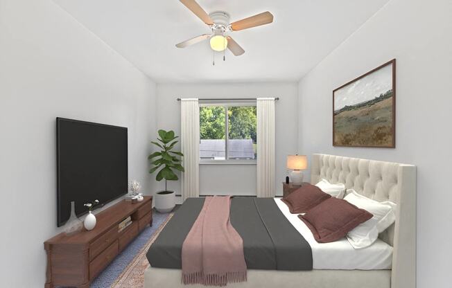 a bedroom with a bed and a ceiling fan