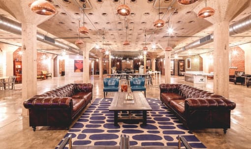 a large lobby with couches and chairs and a table