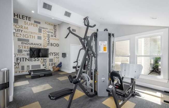 A gym with a wall of fitness related words.
