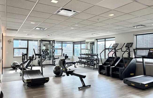 A gym with treadmills, exercise balls, and other equipment.