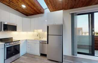 a kitchen with white cabinets and stainless steel appliances