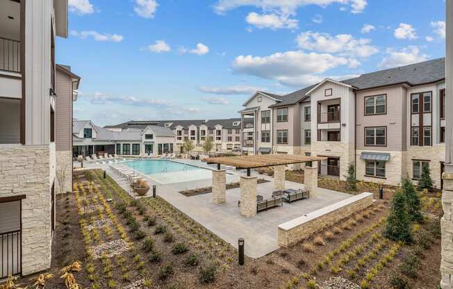 an apartment building with a pool and a courtyard