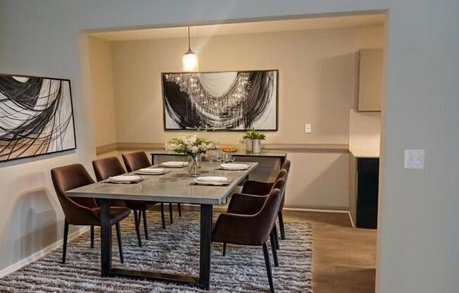 A modern dining room with a large table and chairs.
