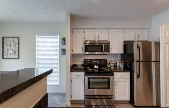This is a photo of the kitchen of the 1100 square foot 2 bedroom Kettering floor plan at Washington Park Apartments in Centerville, OH.