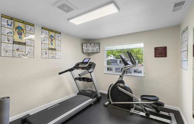 Resident Fitness Facility with exercise equipment and a window at Park Edmonds Apartment Homes, Washington