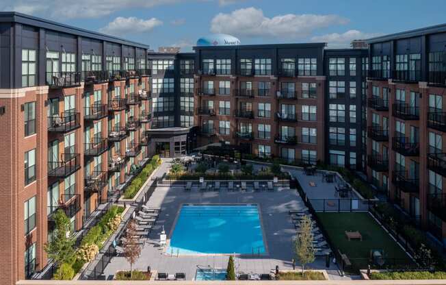 an aerial view of a large pool in front of a building