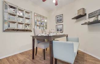 A dining room with a table and chairs.