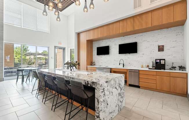 A kitchen with a marble island and wooden cabinets.