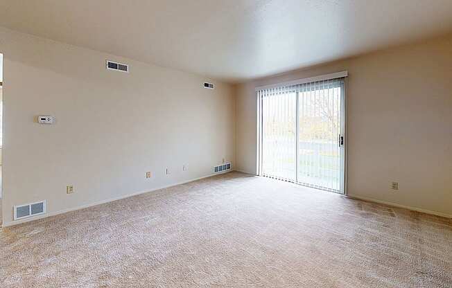 living room with a sliding glass door to private patio