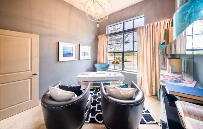a living room with two chairs and a table and a window at Azul Baldwin Park, Orlando, 32814