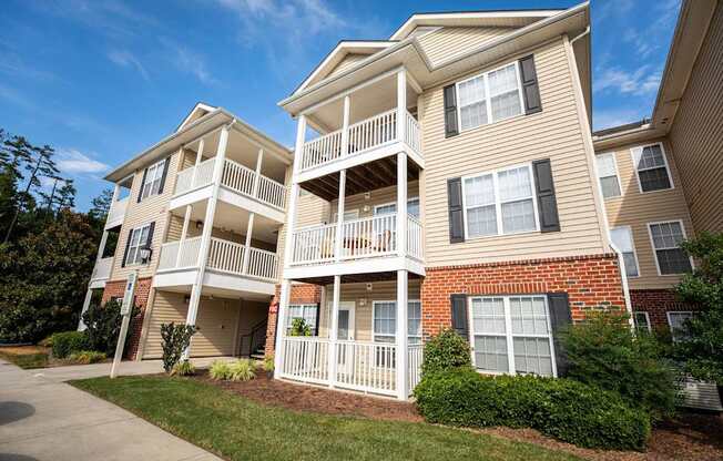 A two-story apartment building with a balcony on the second floor.