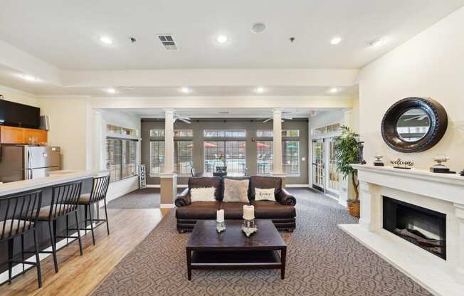 a living room with a couch and a coffee table and a fireplace