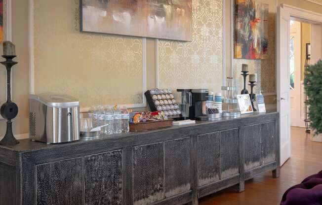 a coffee bar with a coffee machine and a toaster on top of a wooden counter