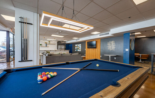 a pool table in a room with a tv